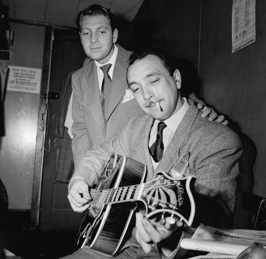 Photo of Django Reinhardt playing a guitar