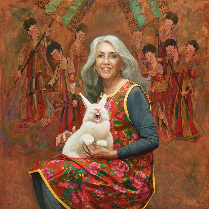 Portrait of a woman holding holding a white rabbit on her lap