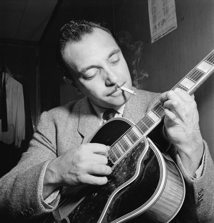 Photo of Django Reinhardt playing a guitar