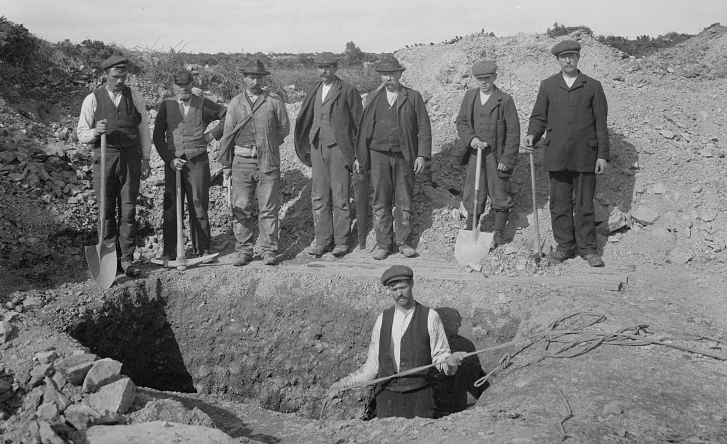 Group of men digging a hole