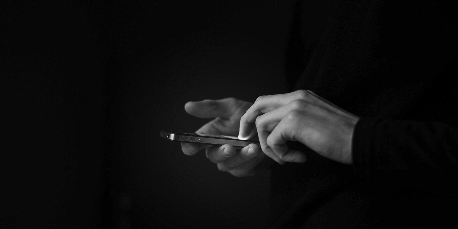 Close up photo of a pair of hands using a smartphone
