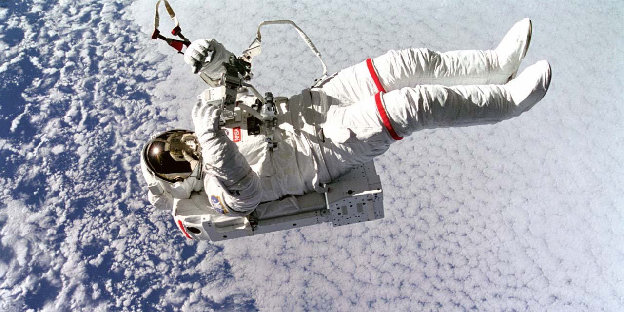 Astronaut on a space-walk above planet Earth
